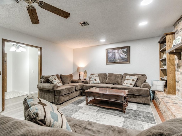 living room with wood finished floors, recessed lighting, ceiling fan, and a textured ceiling
