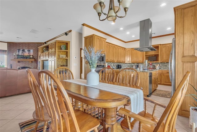 28256 N County Road 3210th Rd, Wynnewood, OK 73098 - dining space with light tile patterned flooring, a chandelier, crown molding, a brick fireplace, and recessed lighting