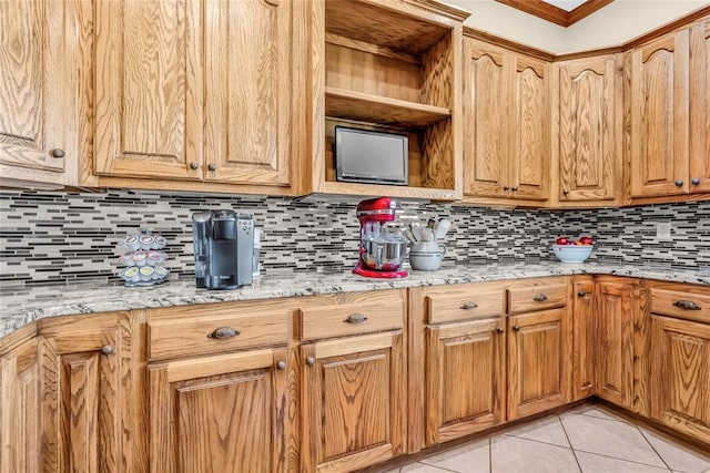 28256 N County Road 3210th Rd, Wynnewood, OK 73098 - kitchen featuring backsplash, light tile patterned floors, light stone countertops, and crown molding