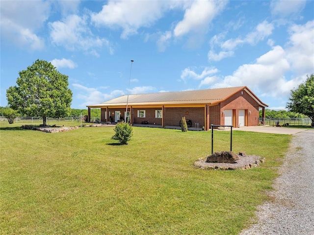 28256 N County Road 3210th Rd, Wynnewood, OK 73098 - single story home featuring gravel driveway, a garage, and brick siding