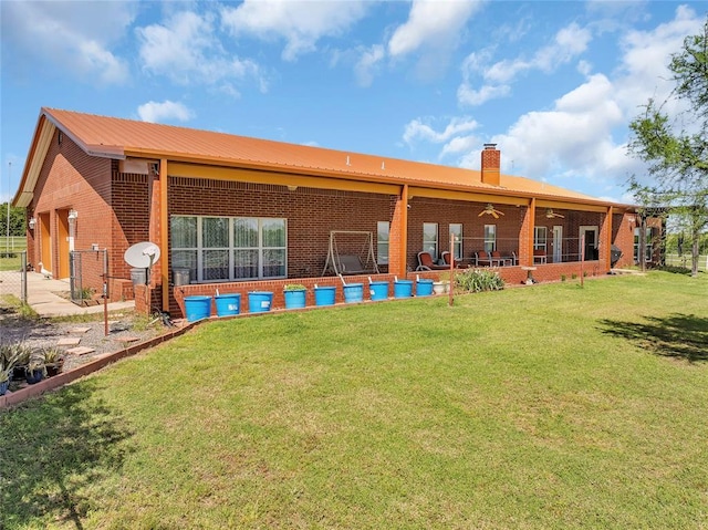 28256 N County Road 3210th Rd, Wynnewood, OK 73098 - back of house with a chimney, brick siding, ceiling fan, and metal roof