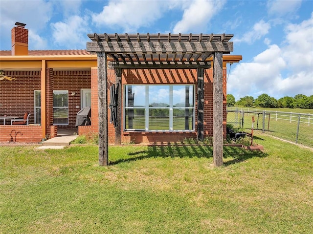 28256 N County Road 3210th Rd, Wynnewood, OK 73098 - rear view of house featuring a chimney, a pergola, and brick siding