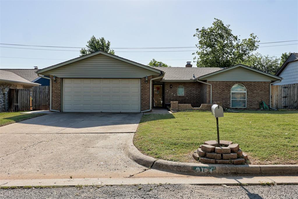 9104 Raven Ave, Oklahoma City, OK 73132 - ranch-style home featuring a garage, concrete driveway, and brick siding