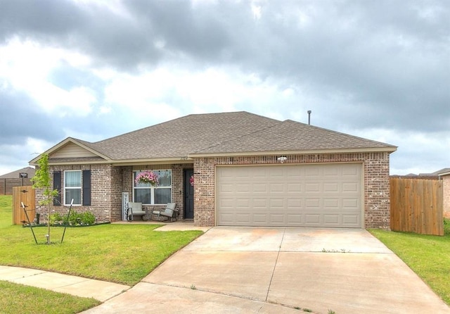 11704 NW 99th Ter, Yukon, OK 73099 - view of front of home featuring brick siding, concrete driveway, and a shingled roof