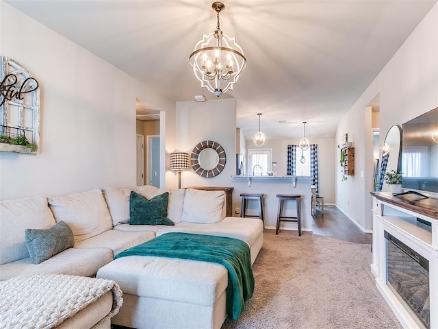11704 NW 99th Ter, Yukon, OK 73099 - carpeted living area featuring a chandelier, baseboards, and healthy amount of natural light