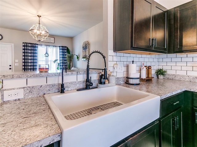 11704 NW 99th Ter, Yukon, OK 73099 - kitchen featuring a sink, light countertops, tasteful backsplash, and a chandelier