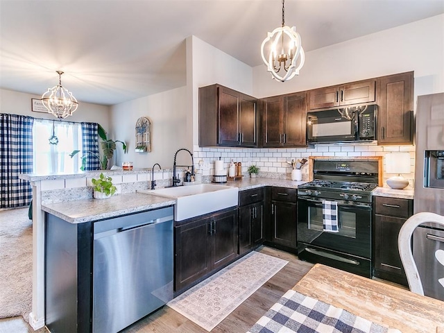 11704 NW 99th Ter, Yukon, OK 73099 - kitchen featuring black appliances, a chandelier, a sink, and a peninsula
