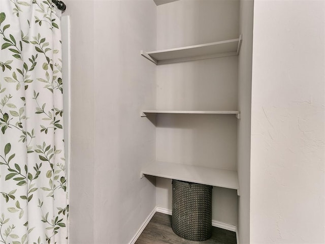 11704 NW 99th Ter, Yukon, OK 73099 - interior space featuring baseboards, wood finished floors, and a shower with shower curtain