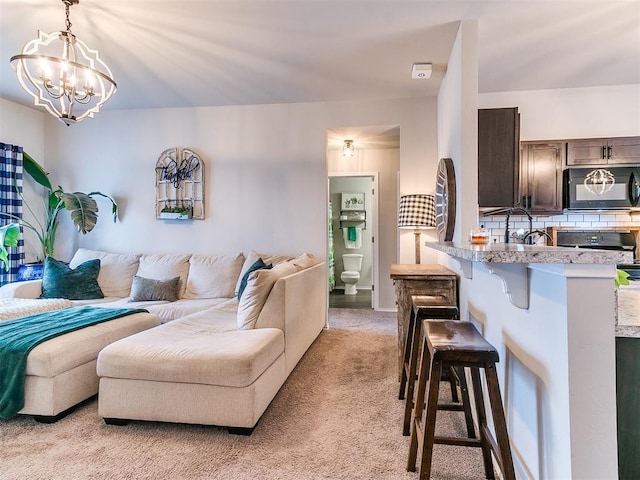 11704 NW 99th Ter, Yukon, OK 73099 - living area featuring light colored carpet and a chandelier