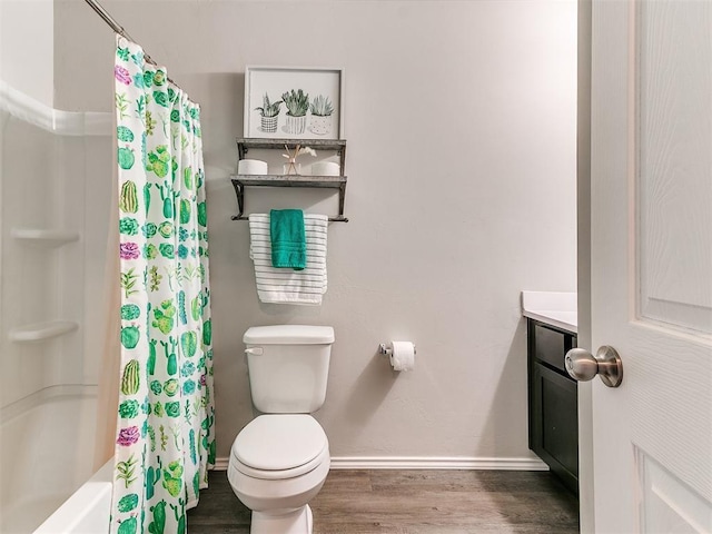 11704 NW 99th Ter, Yukon, OK 73099 - bathroom featuring baseboards, wood finished floors, toilet, shower / bathtub combination with curtain, and vanity