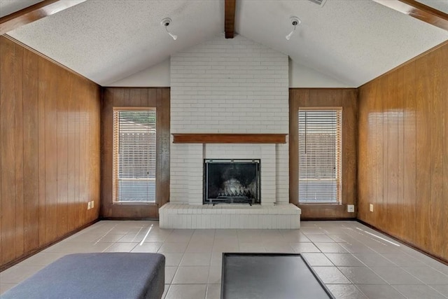 708 Cross Timbers Dr, Moore, OK 73160 - tiled living area with wood walls, a fireplace, and a textured ceiling