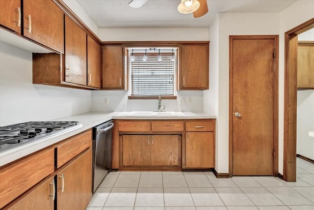 708 Cross Timbers Dr, Moore, OK 73160 - kitchen featuring a sink, appliances with stainless steel finishes, light countertops, and brown cabinets