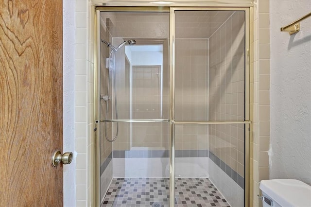 708 Cross Timbers Dr, Moore, OK 73160 - full bath with a textured wall, toilet, and a stall shower