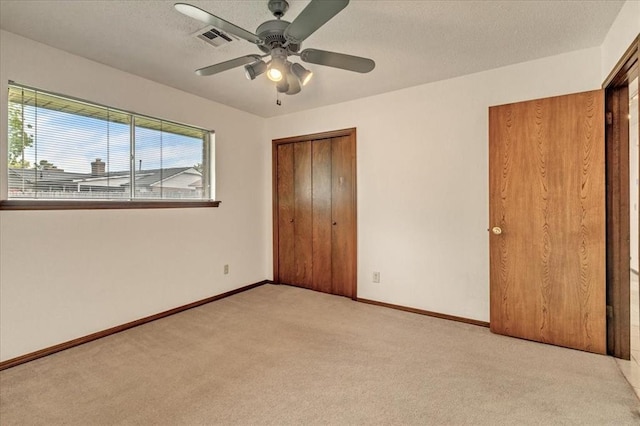 708 Cross Timbers Dr, Moore, OK 73160 - unfurnished bedroom with carpet, baseboards, ceiling fan, and a textured ceiling
