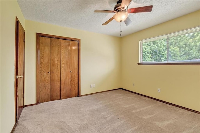 708 Cross Timbers Dr, Moore, OK 73160 - unfurnished bedroom with a textured ceiling, carpet, a closet, a ceiling fan, and baseboards