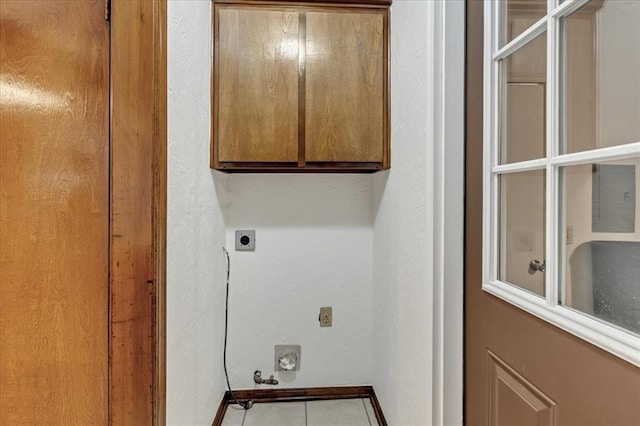 708 Cross Timbers Dr, Moore, OK 73160 - laundry room with cabinet space, electric dryer hookup, baseboards, and tile patterned flooring
