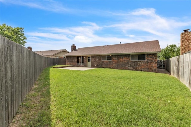 708 Cross Timbers Dr, Moore, OK 73160 - back of property featuring a patio, a chimney, and brick siding