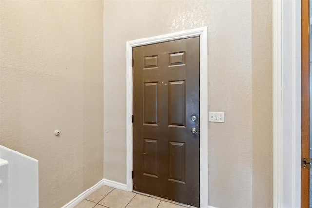 316 SE 6th St, Moore, OK 73160 - entryway with light tile patterned flooring, a textured wall, and baseboards