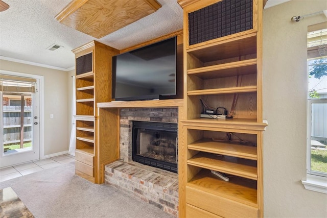 316 SE 6th St, Moore, OK 73160 - tiled living area with ornamental molding, a fireplace with raised hearth, a textured ceiling, and baseboards