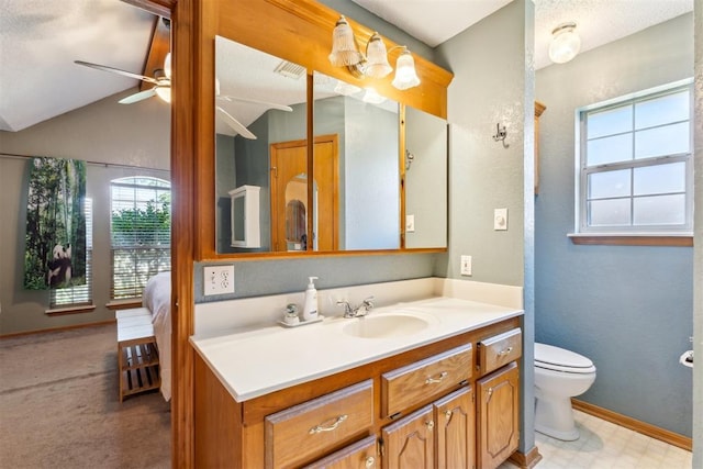 316 SE 6th St, Moore, OK 73160 - bathroom featuring vanity, toilet, ceiling fan, baseboards, and lofted ceiling