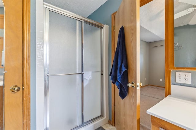 316 SE 6th St, Moore, OK 73160 - full bathroom with a stall shower, vanity, a textured ceiling, and baseboards