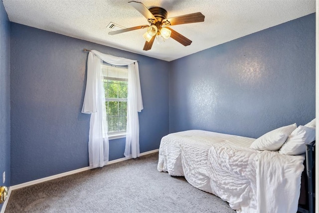 316 SE 6th St, Moore, OK 73160 - carpeted bedroom featuring a textured wall, a ceiling fan, baseboards, and a textured ceiling