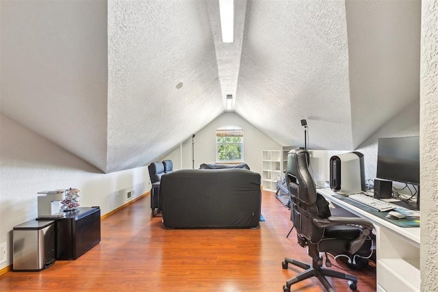316 SE 6th St, Moore, OK 73160 - home office featuring wood finished floors, vaulted ceiling, a textured ceiling, and baseboards
