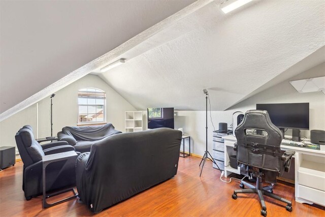 316 SE 6th St, Moore, OK 73160 - living room with lofted ceiling, wood finished floors, a desk, and a textured ceiling