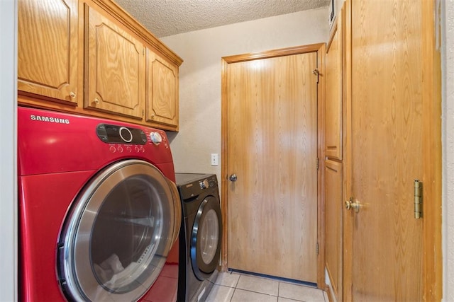 316 SE 6th St, Moore, OK 73160 - washroom with washer and clothes dryer, cabinet space, light tile patterned floors, and a textured ceiling