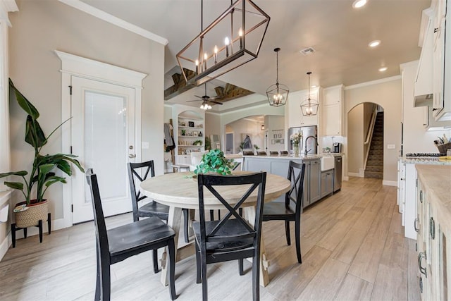 12004 SW 49th St, Mustang, OK 73064 - dining area with arched walkways, ornamental molding, recessed lighting, ceiling fan, and stairs