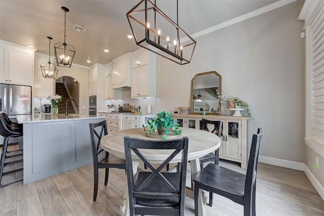 12004 SW 49th St, Mustang, OK 73064 - dining space with ornamental molding, recessed lighting, light wood-style floors, baseboards, and a chandelier
