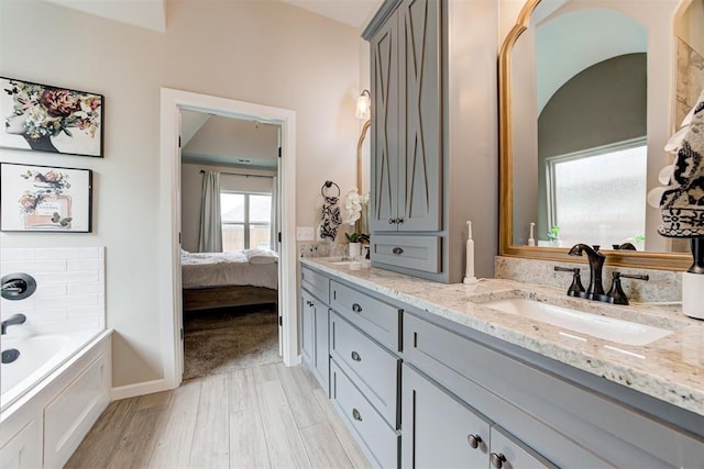 12004 SW 49th St, Mustang, OK 73064 - bathroom featuring double vanity, a bath, and ensuite bathroom