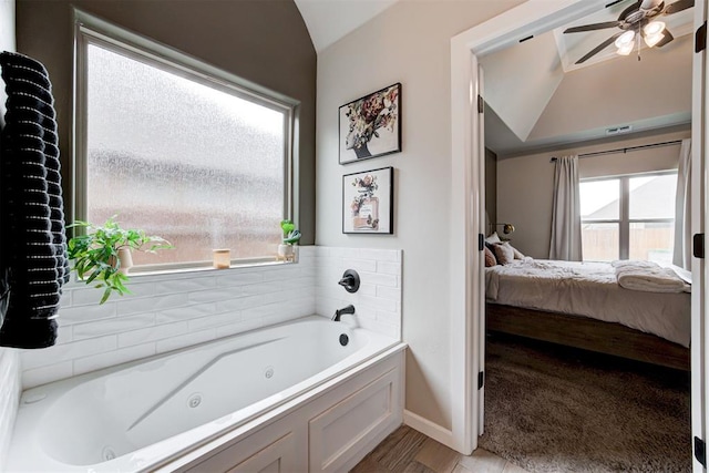 12004 SW 49th St, Mustang, OK 73064 - full bathroom featuring ensuite bathroom, lofted ceiling, a ceiling fan, a tub with jets, and baseboards