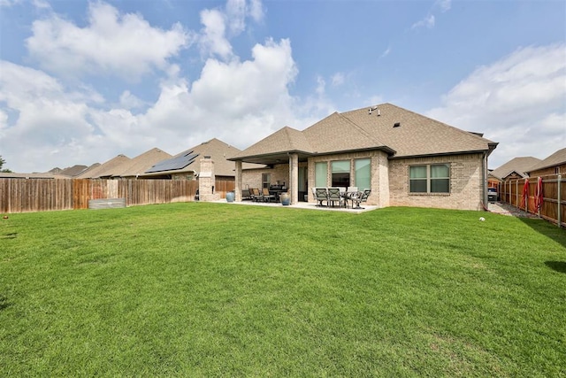 12004 SW 49th St, Mustang, OK 73064 - rear view of house featuring a shingled roof, a patio area, and brick siding