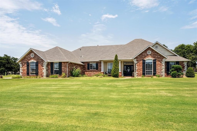 16523 Roserock Cir, Choctaw, OK 73020 - view of front of property with a front yard, a shingled roof, and brick siding