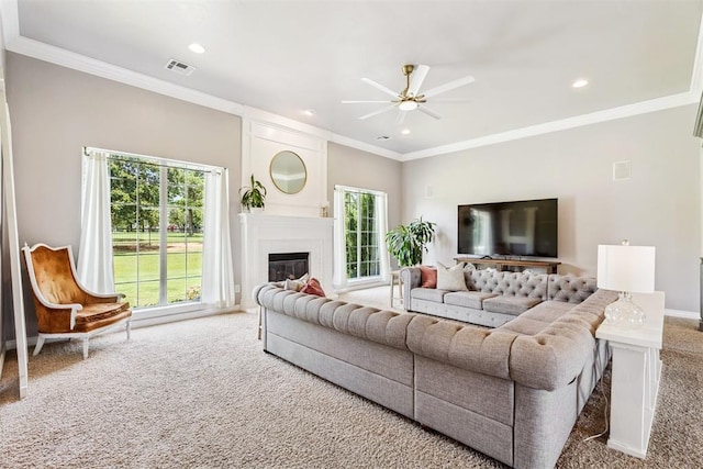 16523 Roserock Cir, Choctaw, OK 73020 - living area with carpet, a ceiling fan, ornamental molding, a glass covered fireplace, and recessed lighting