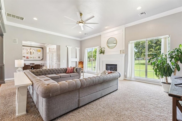 16523 Roserock Cir, Choctaw, OK 73020 - carpeted living room featuring ceiling fan, a glass covered fireplace, a chandelier, ornamental molding, and recessed lighting