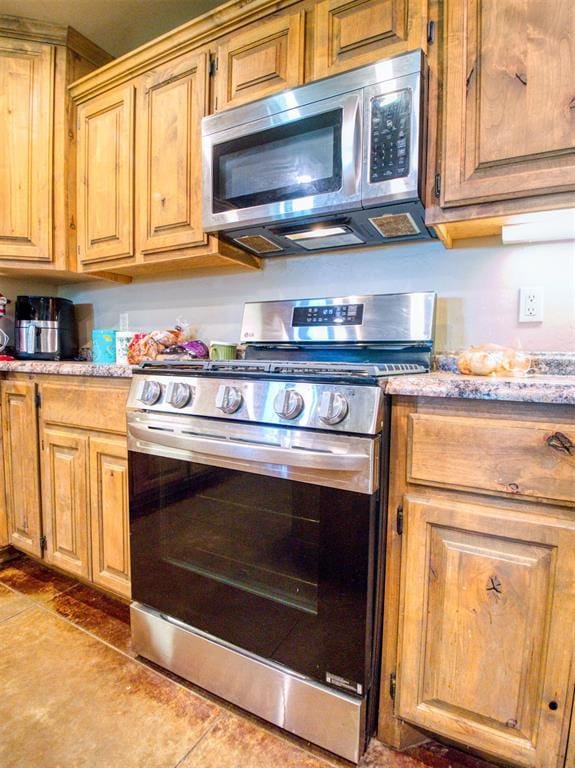 34325 E 1070th Rd, Mcloud, OK 74851 - kitchen with appliances with stainless steel finishes, tile patterned floors, and light stone counters
