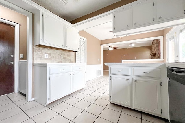 8409 Bigwood Dr, Oklahoma City, OK 73135 - kitchen with stainless steel dishwasher, light tile patterned flooring, white cabinetry, tasteful backsplash, and ceiling fan