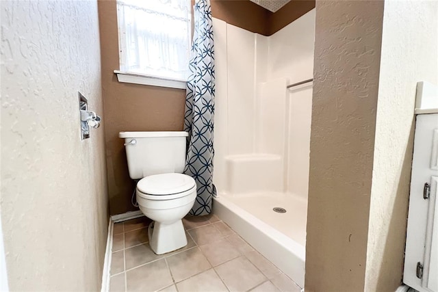 8409 Bigwood Dr, Oklahoma City, OK 73135 - bathroom with a textured wall, tile patterned flooring, a shower stall, and toilet
