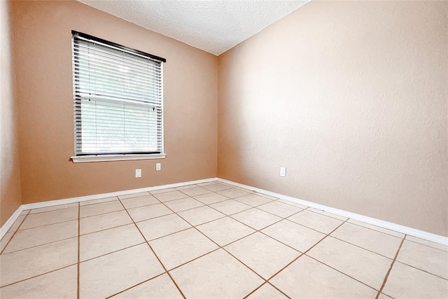 8409 Bigwood Dr, Oklahoma City, OK 73135 - unfurnished room with light tile patterned floors, a textured ceiling, and baseboards