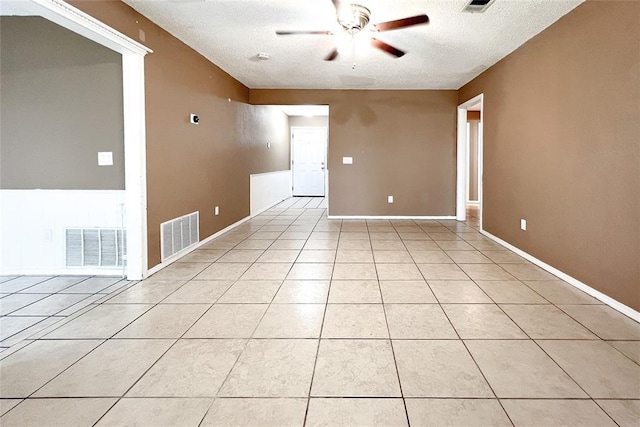 8409 Bigwood Dr, Oklahoma City, OK 73135 - spare room with ceiling fan, a textured ceiling, light tile patterned floors, and baseboards