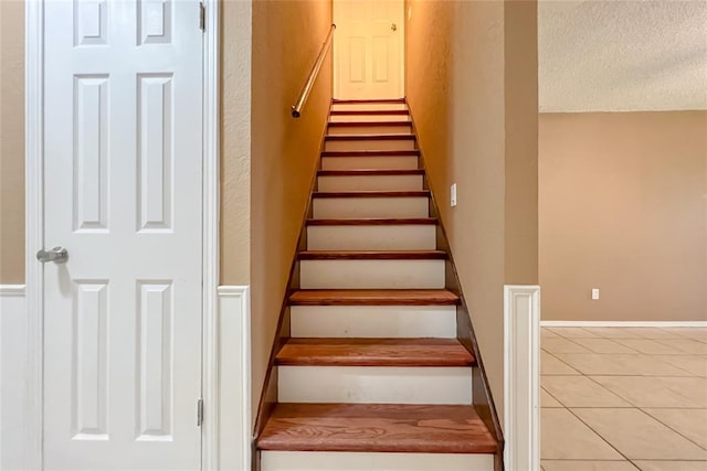 8409 Bigwood Dr, Oklahoma City, OK 73135 - stairway featuring tile patterned floors and a textured ceiling