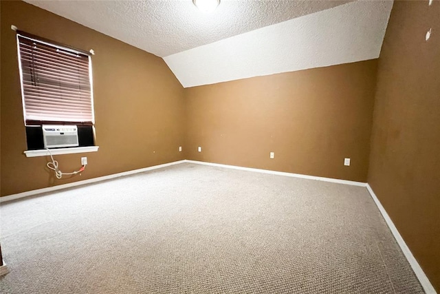 8409 Bigwood Dr, Oklahoma City, OK 73135 - additional living space featuring cooling unit, carpet flooring, vaulted ceiling, a textured ceiling, and baseboards