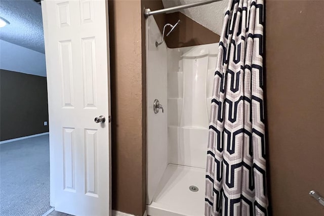 8409 Bigwood Dr, Oklahoma City, OK 73135 - full bathroom featuring a textured ceiling, a stall shower, and baseboards