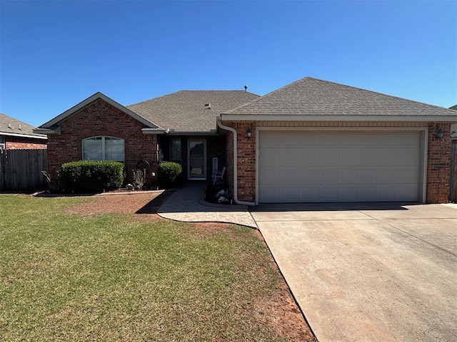 520 E Juniper Ln, Mustang, OK 73064 - single story home with brick siding, roof with shingles, concrete driveway, and a garage