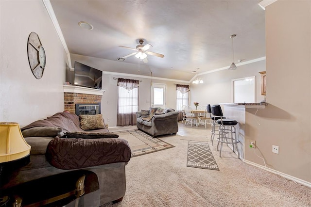 520 E Juniper Ln, Mustang, OK 73064 - living room featuring light carpet, a brick fireplace, crown molding, a ceiling fan, and baseboards