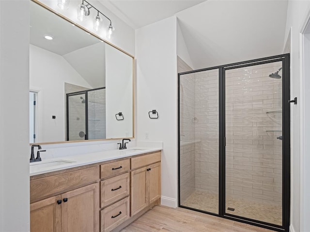 7909 NW 162nd St, Edmond, OK 73013 - full bath featuring double vanity, a stall shower, lofted ceiling, and wood finished floors