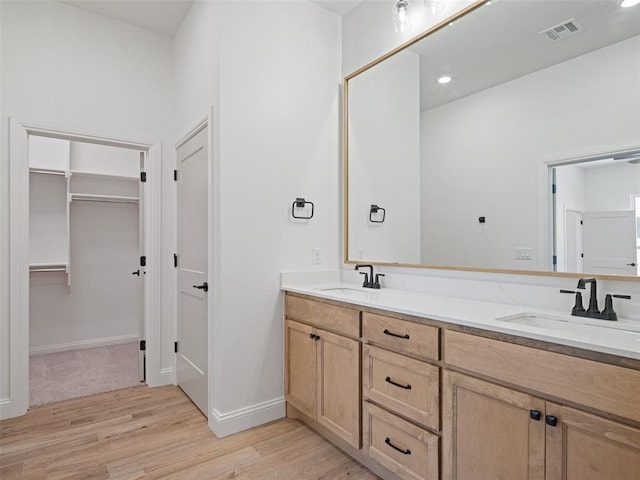 7909 NW 162nd St, Edmond, OK 73013 - full bathroom with double vanity, wood finished floors, a spacious closet, and recessed lighting
