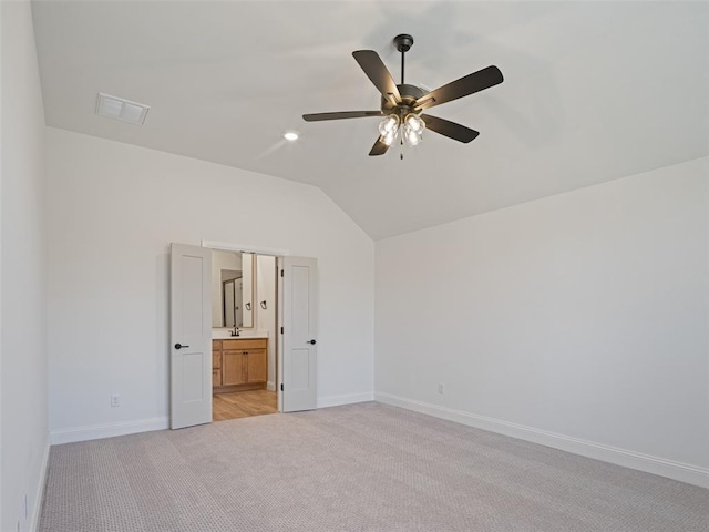 7909 NW 162nd St, Edmond, OK 73013 - unfurnished bedroom with vaulted ceiling, light colored carpet, baseboards, a sink, and ceiling fan
